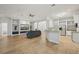 Open-concept living space with an entertainment center, hardwood flooring, and a view of the kitchen at 707 9Th Sw Ave, Ruskin, FL 33570