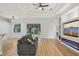 Living room with a view to the backyard, open layout, and modern entertainment center for gatherings at 707 9Th Sw Ave, Ruskin, FL 33570