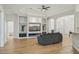 Bright living room featuring a built-in entertainment center, modern lighting, and luxury vinyl flooring at 707 9Th Sw Ave, Ruskin, FL 33570