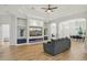 Spacious living area with a modern entertainment center, neutral decor, and light-colored hardwood floors at 707 9Th Sw Ave, Ruskin, FL 33570
