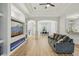 Open-plan living space with hardwood floors, an entertainment center, and access to other rooms at 707 9Th Sw Ave, Ruskin, FL 33570
