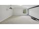 Bright theater room with projector, screen, window, and neutral carpet at 707 9Th Sw Ave, Ruskin, FL 33570