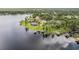 An aerial view of several waterfront homes with private docks and stunning lakeside views at 707 Warren Rd, Lutz, FL 33548