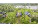 Aerial view showcasing property, surrounding greenery, and nearby waterfront at 707 Warren Rd, Lutz, FL 33548
