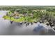 An aerial view of several waterfront homes with private docks and stunning lakeside views surrounded by lush greenery at 707 Warren Rd, Lutz, FL 33548