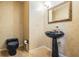 Charming powder room with black pedestal sink, elegant mirror, and floral wallpaper at 707 Warren Rd, Lutz, FL 33548