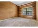 Cozy bedroom with carpet, built-in shelving, and a large window at 707 Warren Rd, Lutz, FL 33548