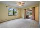 Bright, large bedroom with natural light and access to an outdoor patio/garden at 707 Warren Rd, Lutz, FL 33548