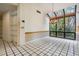 Dining area with decorative chandelier and a large window with views of lush greenery at 707 Warren Rd, Lutz, FL 33548