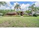 Charming single-Gathering home with mature landscaping and a well-manicured lawn at 707 Warren Rd, Lutz, FL 33548