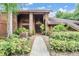 Inviting home featuring mature landscaping and a charming exterior walkway at 707 Warren Rd, Lutz, FL 33548