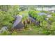 Stunning home featuring lush landscaping, mature palms, and well-maintained lawn at 707 Warren Rd, Lutz, FL 33548