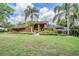 Charming single-Gathering home with mature landscaping and a well-manicured lawn at 707 Warren Rd, Lutz, FL 33548