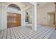 Elegant foyer with tile flooring and large windows, showcasing the home's bright interior at 707 Warren Rd, Lutz, FL 33548