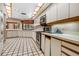 Bright kitchen with white cabinets, stainless steel appliances, and decorative ceiling lights at 707 Warren Rd, Lutz, FL 33548