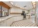 Bright kitchen featuring white cabinets, modern appliances, and a unique tile floor at 707 Warren Rd, Lutz, FL 33548