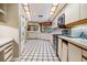 Well-lit kitchen with white cabinets, stainless steel appliances, and unique ceiling lights at 707 Warren Rd, Lutz, FL 33548