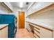 Functional laundry room with a front-load washer/dryer, tile flooring, and built-in cabinetry at 707 Warren Rd, Lutz, FL 33548