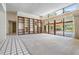 Large living room featuring built-in shelving and sliding glass doors to the backyard pool at 707 Warren Rd, Lutz, FL 33548