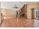 Living room featuring a high ceiling, a cozy brick fireplace, and natural lighting at 707 Warren Rd, Lutz, FL 33548
