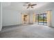Living room with carpet and sliding glass doors to the pool area at 707 Warren Rd, Lutz, FL 33548