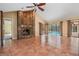 Spacious living room featuring a brick fireplace and sliding glass doors to the pool at 707 Warren Rd, Lutz, FL 33548