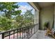 Relax on the balcony with views of mature trees providing shade and scenery at 727 Coral Reef Dr, Tampa, FL 33602