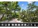 Balcony view showcases lush greenery and the community's landscape and mature trees at 727 Coral Reef Dr, Tampa, FL 33602