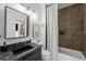 Bathroom features a modern vanity with granite counters and tiled shower/tub at 727 Coral Reef Dr, Tampa, FL 33602