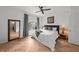 Bright bedroom with hardwood floors, large window, walk-in closet, and gray and white bedding at 727 Coral Reef Dr, Tampa, FL 33602