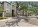 Exterior view of condo building with attached garages, mature shade trees and well-maintained landscaping at 727 Coral Reef Dr, Tampa, FL 33602