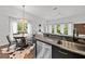Bright open dining room features stainless steel appliances and an abundance of natural light through the windows at 727 Coral Reef Dr, Tampa, FL 33602