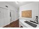 Hallway features hardwood flooring and a modern table with artwork at 727 Coral Reef Dr, Tampa, FL 33602