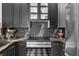 Modern kitchen with black marble countertops and cabinets, stainless steel appliances, and sleek finishes at 727 Coral Reef Dr, Tampa, FL 33602