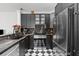 Modern kitchen features black cabinets, stainless steel appliances, and designer backsplash at 727 Coral Reef Dr, Tampa, FL 33602