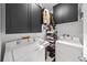 Functional laundry room features washer, dryer, storage cabinets, and organization racks for efficient space usage at 727 Coral Reef Dr, Tampa, FL 33602