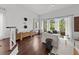 Open living room boasts hardwood floors, lots of natural light, and a balcony at 727 Coral Reef Dr, Tampa, FL 33602