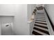 Staircase with white risers and dark wood treads, featuring white walls at 727 Coral Reef Dr, Tampa, FL 33602