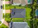 Aerial view showcases the home's backyard and layout with its well-manicured lawn and neighborhood at 751 Cajeput Loop, Tarpon Springs, FL 34689