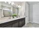 Modern bathroom featuring a double vanity with white countertops and a glass-enclosed shower at 751 Cajeput Loop, Tarpon Springs, FL 34689