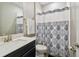 Bathroom featuring a vanity, toilet, and bathtub with a patterned shower curtain at 751 Cajeput Loop, Tarpon Springs, FL 34689