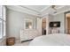 Bedroom featuring a white dresser and a doorway leading to the bathroom and walk-in closet at 751 Cajeput Loop, Tarpon Springs, FL 34689