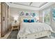 Cozy bedroom with stylish seashell decor, shiplap ceiling, and a king bed with blue accent pillows at 751 Cajeput Loop, Tarpon Springs, FL 34689