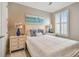 Cozy bedroom with beach-themed decor, white furniture, and shuttered windows at 751 Cajeput Loop, Tarpon Springs, FL 34689