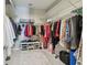Spacious walk-in closet featuring ample storage, built-in shelving, and a variety of hanging options for organization at 751 Cajeput Loop, Tarpon Springs, FL 34689
