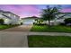 Beautiful single-Gathering home with manicured lawn, brick driveway, and attached two car garage at 751 Cajeput Loop, Tarpon Springs, FL 34689