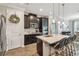 Stylish kitchen island with granite countertops and dark wood cabinets with stainless steel appliances at 751 Cajeput Loop, Tarpon Springs, FL 34689