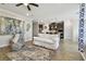 Bright living room with wood flooring, a stylish rug, and an open flow to the kitchen at 751 Cajeput Loop, Tarpon Springs, FL 34689