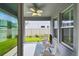Outdoor porch with fan and a view of the backyard through sliding glass doors at 751 Cajeput Loop, Tarpon Springs, FL 34689