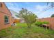 Backyard features a lush garden with a variety of plants in pots, a small tree, and a wood fence at 7591 121St Ter, Largo, FL 33773